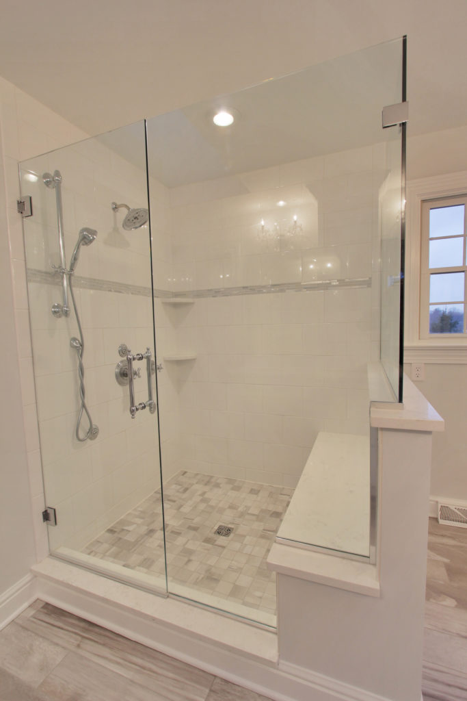 Walk in white tile shower